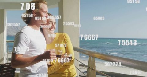 Couple enjoying coffee together on scenic balcony