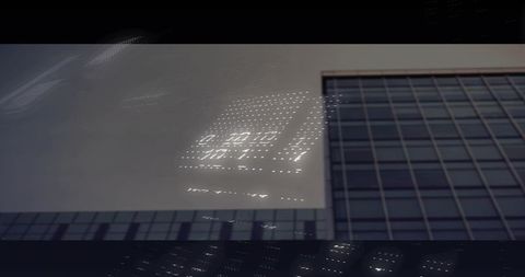 Reflecting led grid on glass facade of modern high-rise, minimalist urban architecture