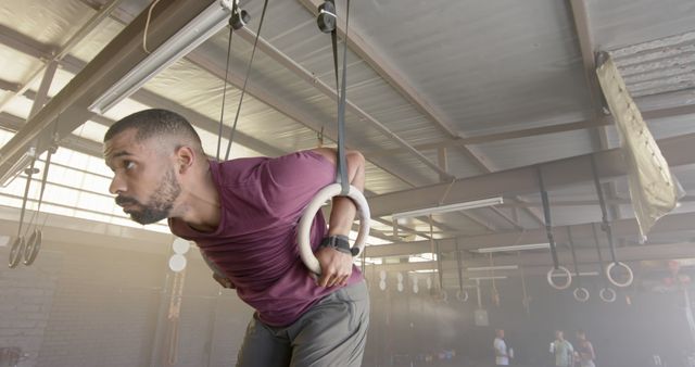 Determined Athlete Training on Gymnastic Rings in Industrial Setting - Download Free Stock Images Pikwizard.com