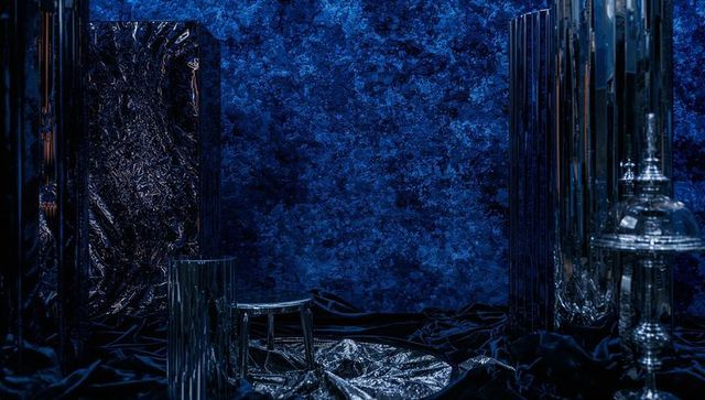 Glistening blue metallic installation showcasing reflective mirrors and sculptural forms