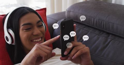 Young Woman Relaxing on Couch Engaging with Social Media