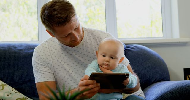 Father Teaching Baby Using a Tablet in Cozy Living Room - Download Free Stock Images Pikwizard.com