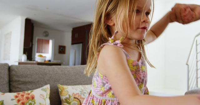 Excited Young Girl Dancing Joyfully in Living Room - Download Free Stock Images Pikwizard.com