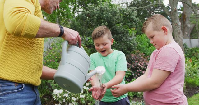 Father and Sons Watering Plants in Garden on a Sunny Day - Download Free Stock Images Pikwizard.com