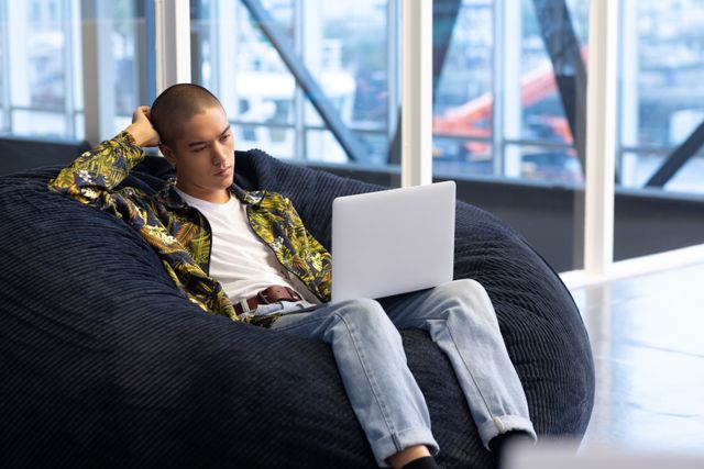 Young Businessman using laptop on a sofa in the office