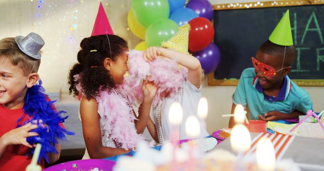 A diverse group of children celebrates a birthday party, with colorful decorations and a cake on the table, with copy space. Joyful expressions and festive attire contribute to the lively atmosphere of the celebration.