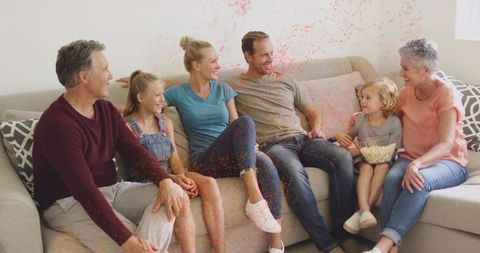 Multi-generational Family Relaxing with Popcorn and Confetti Celebration