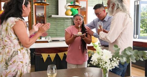 Senior Woman Celebrating Birthday with Diverse Friends at Home