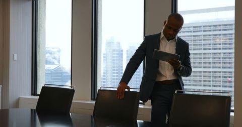 Businessman Engaging with Tablet in Modern Office Setting