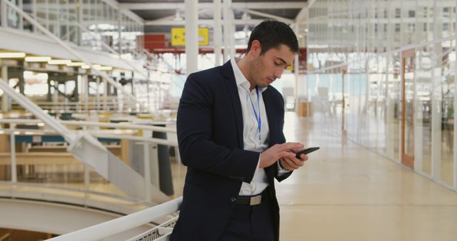 Businessman in suit using smartphone in modern office - Download Free Stock Images Pikwizard.com