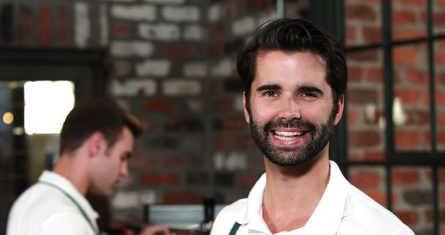 Male Barista Smiling in Modern Coffee Shop Environment - Download Free Stock Images Pikwizard.com