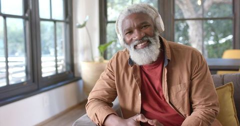 Senior Man Enjoying Wireless Music at Home