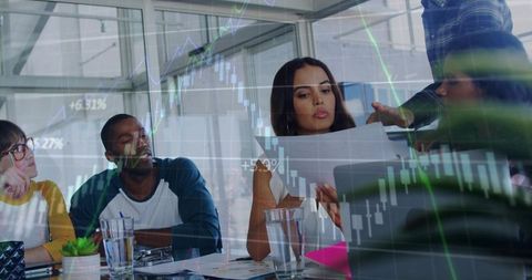 Team reviewing financial documents with stock charts overlay in modern conference room