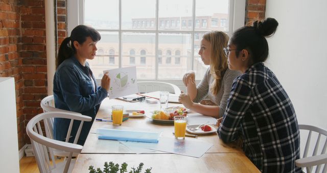 Three Young Women Having a Business Meeting Over Breakfast - Download Free Stock Images Pikwizard.com