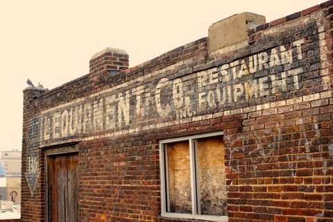 Old Brick Building with Faded Restaurant Sign - Download Free Stock Images Pikwizard.com