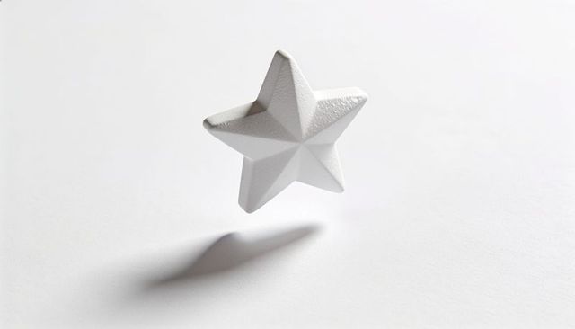 Floating white faceted five-pointed star casting soft shadow on seamless white background