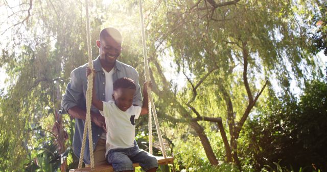 Father Pushing Son on Swing in Sunny Park - Download Free Stock Images Pikwizard.com