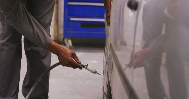 Mechanic Repairing Car With Pneumatic Tool in Auto Workshop - Download Free Stock Images Pikwizard.com