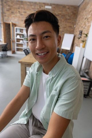 Smiling Man in Casual Attire Collaborating in Modern Office