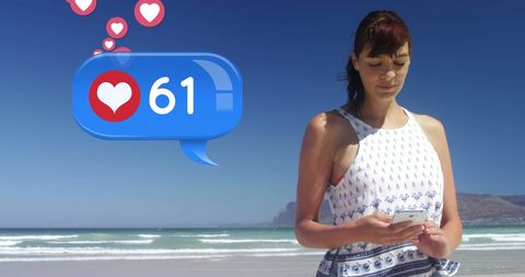 Woman enjoying social media on beach with likes increasing