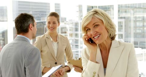 Businesswoman Laughing on Phone in Modern Office Environment - Download Free Stock Images Pikwizard.com
