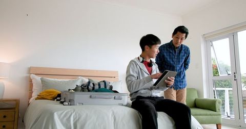 Father and Son Preparing Luggage for Family Getaway