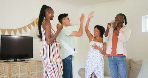 Friends Celebrating Home Gathering with Joyful Moments