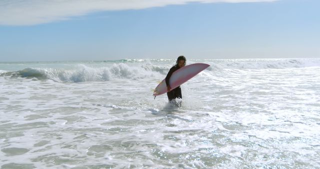 Woman Surfing on a Sunny Day Emerging from Ocean Waves - Download Free Stock Images Pikwizard.com