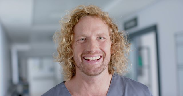 Happy Healthcare Worker Smiling in Hospital Corridor - Download Free Stock Images Pikwizard.com