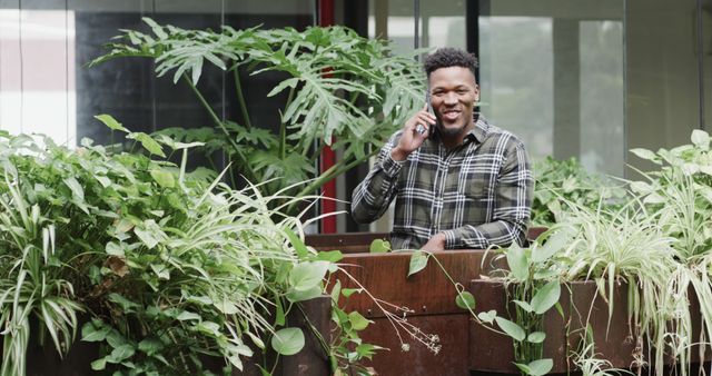 Happy Man Talking on Phone in Greenhouse - Download Free Stock Images Pikwizard.com