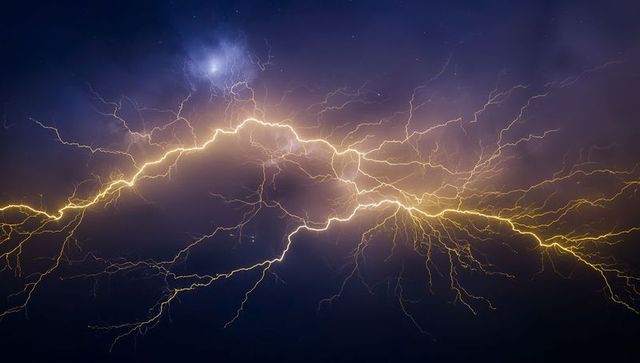 Dramatic Branching Lightning Strike Illuminates Tormented Night Sky
