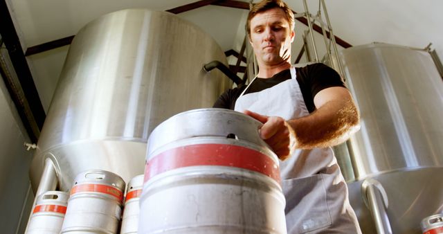 Brewery Worker Inspecting Kegs in Brewery Facility - Download Free Stock Images Pikwizard.com