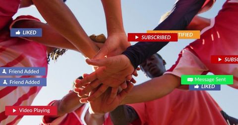 Youth soccer team huddling and stacking hands with social media notification overlays