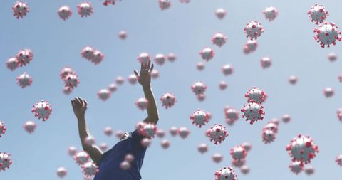 Soccer Player Surrounded by COVID-19 Viruses in Surreal Scene