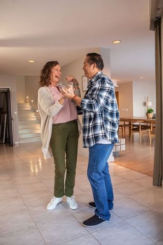 Senior Couple Dancing Joyfully in Cozy Living Room Setting