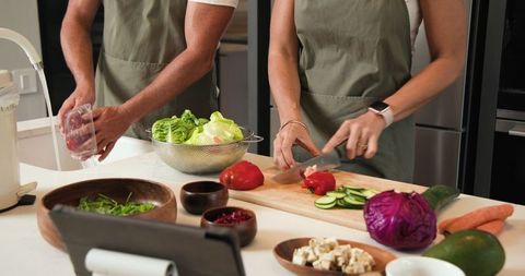 Senior Couple Collaborative Cooking Fresh Meal Kitchen Counter