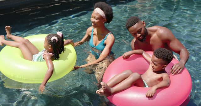 Happy African American Family Enjoying Time Together in Swimming Pool - Download Free Stock Images Pikwizard.com