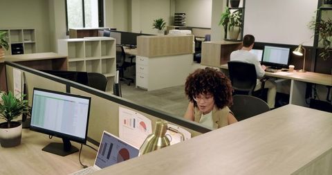 Diverse Team Collaborating in Modern Open-Plan Office with Technology