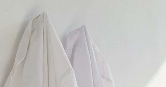 Two White Lab Coats Hanging on Wall Hooks - Download Free Stock Images Pikwizard.com