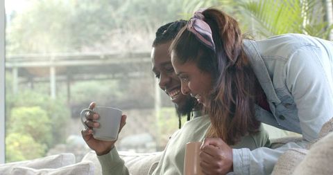 Sharing Morning Coffee on Cozy Couch by Window, Intimate Relaxed Home Moment