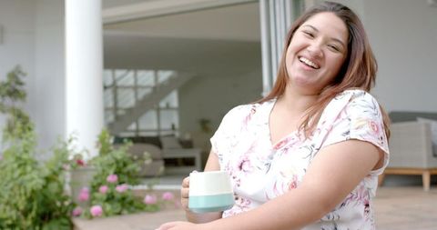 Joyful Woman Relaxing with Coffee on Terrace