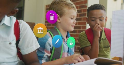 Diverse Schoolboys Studying with Educational Icons