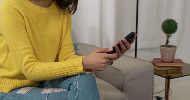 Woman in Yellow Sweater Texting on Smartphone at Home - Download Free Stock Images Pikwizard.com