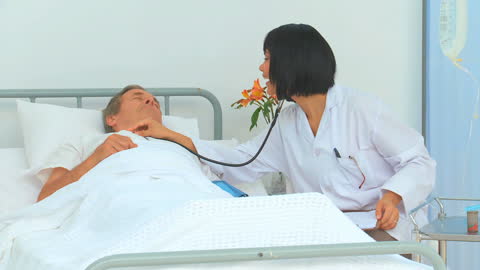 Nurse Using Stethoscope During Patient Evaluation