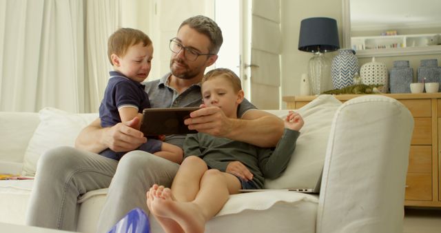 Comforting Father Reading to Upset Kids on Sofa at Home - Download Free Stock Images Pikwizard.com