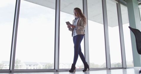 Young Businesswoman Using Tablet in Modern Office