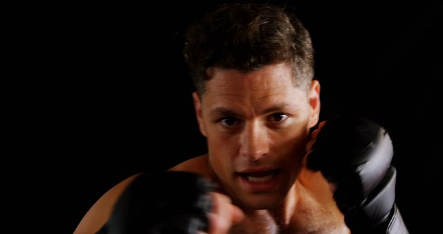 Focused Male Boxer Ready for Fight on Black Background - Download Free Stock Images Pikwizard.com