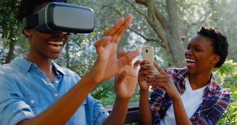 Young Sisters Enjoying VR Experience Together Outdoors - Download Free Stock Images Pikwizard.com