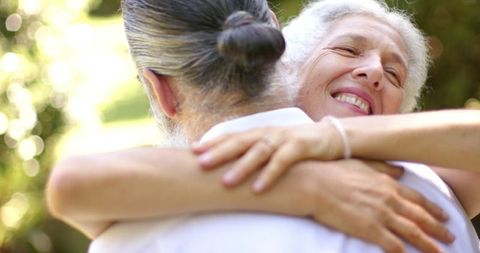 Senior couple sharing joyful embrace at outdoor occasion