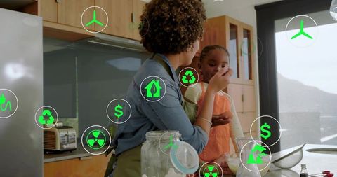 Mother teaching child baking in modern kitchen with green sustainability and money icons